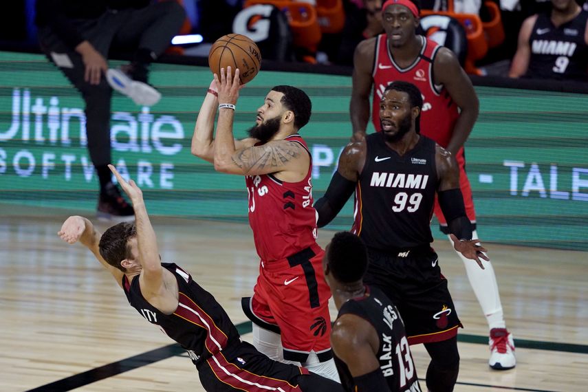 Fred VanVleet (23) de los Raptors de Toronto dispara al aro frente a Goran Dragic del Heat de Miami, el lunes 3 de agosto de 2020, en Lake Buena Vista, Florida. Los Raptors ganaron 107-103.&nbsp;