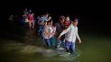 Migrantes, la mayoría centroamericanos, caminan por un río al llegar a la frontera en Roma, Texas. Migrantes, la mayoría centroamericanos, caminan por un río al llegar a la frontera en Roma, Texas.