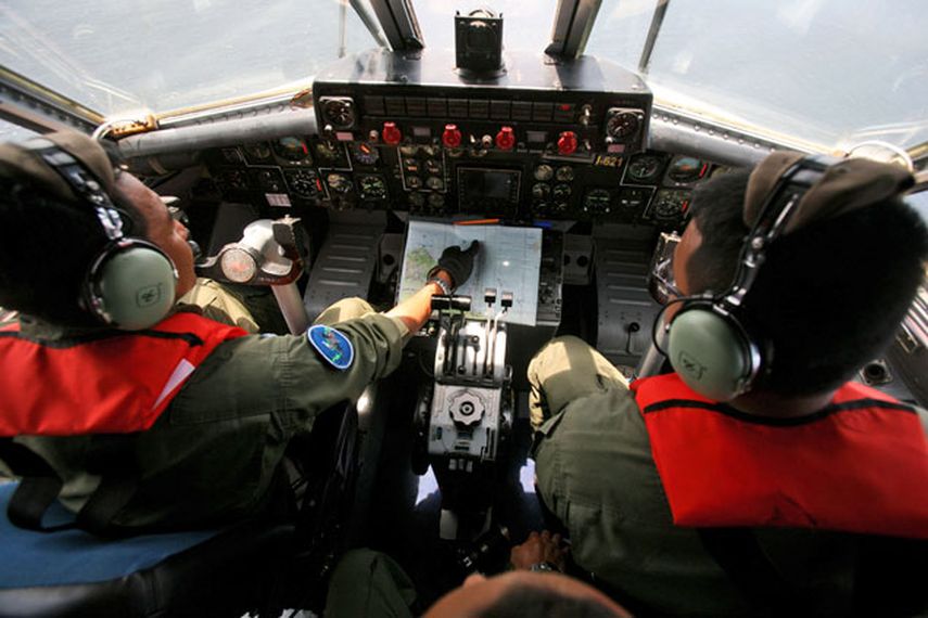 Dos pilotos de marina indonesios durante la búsqueda del desaparecido avión Boeing 777 de Malaysian Airlines en aguas fronterizas de Indonesia, Malasia y Tailandia, cerca de los estrechos de Malaca. (Foto AP/Binsar Bakkara)