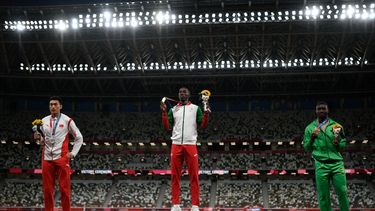 El medallista de oro portugués Pedro Pablo Pichardo (C), nacido en Cuba, el medallista de plata de China Zhu Yaming (izq.) y el medallista de bronce de Burkina Faso Hugues Fabrice Zango (der.) posan en el podio después del evento de triple salto masculino durante los Juegos Olímpicos de Tokio 2020