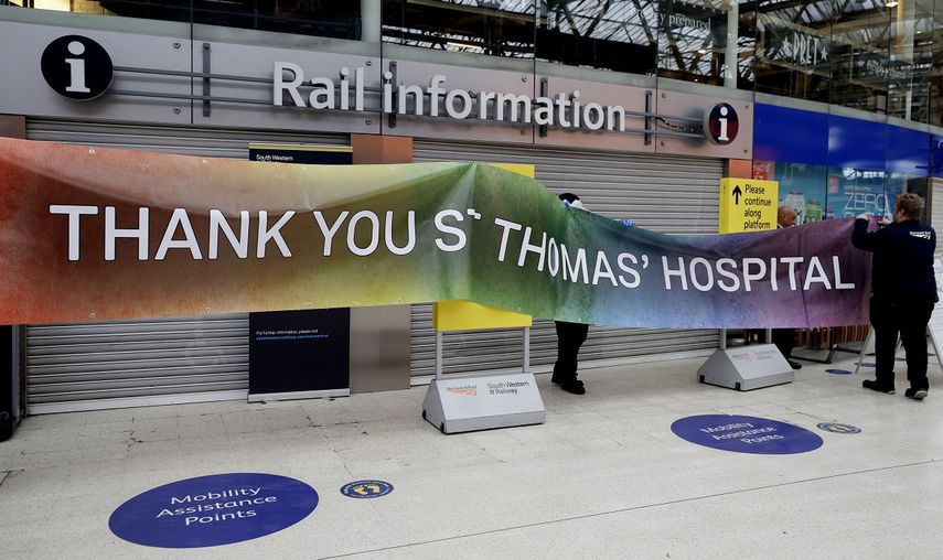 Personal de la estaci&oacute;n ferroviaria Waterloo en Londres instala un cartel de agradecimiento al vecino hospital St. Thomas, Londres, martes 18 de abril de 2020.&nbsp;
