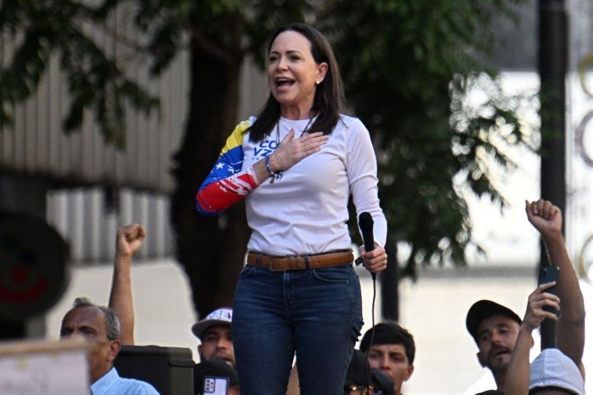 La líder opositora venezolana María Corina Machado (izq.) hace un gesto durante una protesta convocada por la oposición en vísperas de la investidura presidencial, en Caracas el 9 de enero de 2025.