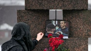 Una mujer toca la fotografía de Alexei Navalny tras dejar flores en homenaje al fallecido líder opositor ruso, en San Petersburgo, Rusia, el sábado 17 de febrero de 2024.&nbsp;