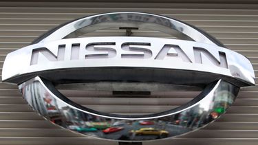 Vehículos reflejados en un logotipo de Nissan Motors Co. en una sala de exhibiciones en el distrito comercial Ginza, de Tokio.&nbsp; &nbsp;