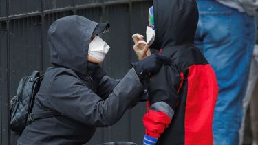 &nbsp;Un estudio revela&nbsp;que muchos m&aacute;s neoyorquinos han tenido el coronavirus que el n&uacute;mero de los confirmados. Una mujer le ajusta la mascarilla a su hijo en Brooklyn, Nueva York, el 23 de abril del 2020.