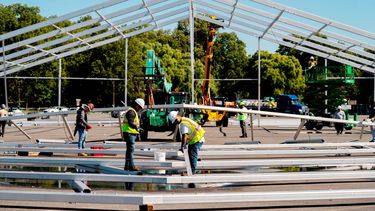 Trabajadores erigen una tienda de campaña en un estacionamiento en Orchard Beach, en el distrito del Bronx, en Nueva York, como albergue temporal para migrantes que están siendo enviados a la ciudad desde estados en la frontera con México.&nbsp;