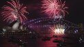 Fuegos artificiales iluminan el puente y la ópera de Sydney en el inicio de los festejos de Año Nuevo, el Sydney, el 31 de diciembre de 2021.