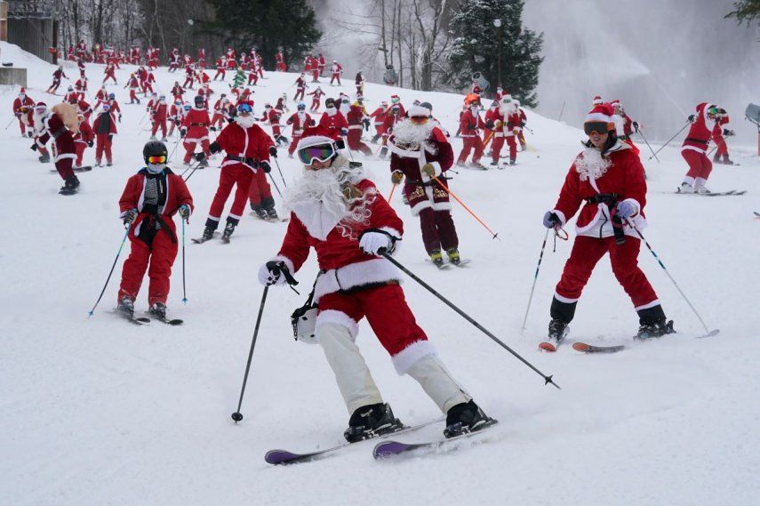 Personas disfrazadas de Santa Claus esquian en un evento caritativo en Sunday River Ski Resort, en Newry, Maine, el 11 de diciembre de 2022.&nbsp; &nbsp;