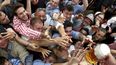 En esta foto del 21 de septiembre de 2019, gente trata de agarrar un vaso de cerveza durante la inauguración del 186to festival de la cerveza Oktoberfest en Múnich, Alemania. Funcionarios bávaros cancelaron el lunes 3 de mayo de 2021 las festividades del Oktoberfest por segundo año consecutivo debido a las preocupaciones sobre la propagación del COVID-19.&nbsp;