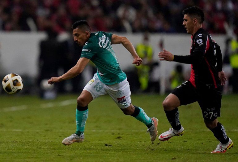 Ángel Mena, del club mexicano León, a la izquierda, y Jesús Angulo, del Atlas, luchan por el balón en la final del Torneo Apertura en Guadalajara del fútbol en México