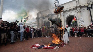 Manifestantes queman una bandera estadounidense frente a Union Station tras el discurso del primer ministro israelí, Benjamin Netanyahu, durante una sesión conjunta del Congreso, en Washington, DC, el 24 de julio de 2024.&nbsp;