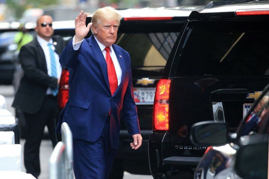 El expresidente Donald Trump, saluda mientras camina hacia un vehículo a la salida de la Torre Trump en la ciudad de Nueva York el 10 de agosto de 2022.
