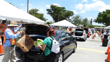 Voluntarios cargan alimentos en un auto en Hialeah. 