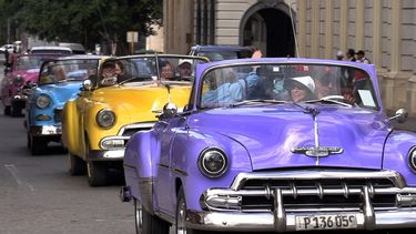Turistas a bordo de automóviles clásicos recorren una calle este sábado, en La Habana, Cuba.