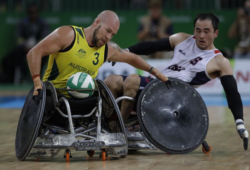 En esta fotografía del 16 de septiembre de 2016 Ryley Batt de australia lucha por el balón con el estadounidense Chuck Aoki durante la final de rugby en silla de ruedas en los Juegos Paralímpicos en Río de Janeiro, Brasil.  