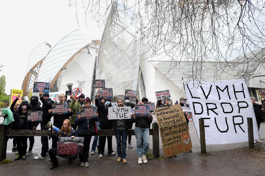ARCHIVO. Manifestantes y miembros del colectivo SIPE (Stop Impunity of Livestock Professionals) sostienen pancartas durante una manifestación contra las pieles frente a la Fundación Louis Vuitton, en París, el 23 de abril, 2023. Ambientalistas atacaron la fachada de la fundación.