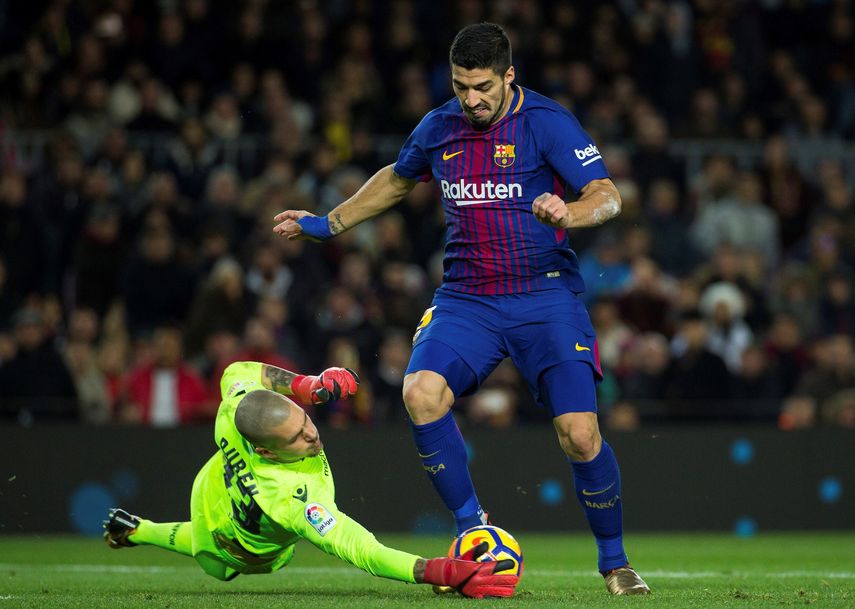 El delantero uruguayo del Barcelona&nbsp;Luis Suárez (derecha) lucha el balón con Rubén Martínez, portero del Deportivo de La Coruña.&nbsp;