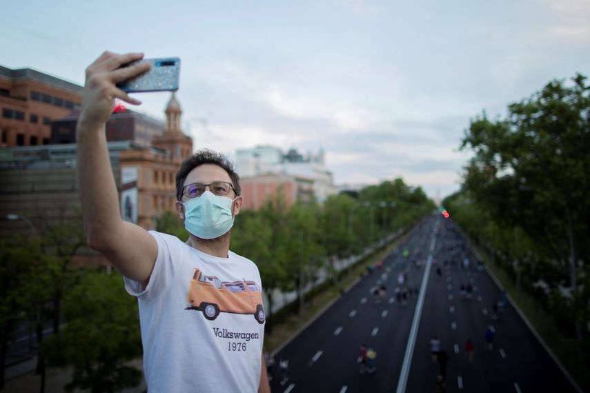 Un hombre se toma una foto con el Paseo de la Castellana de fondo en Madrid, Espa&ntilde;a, el 9 de mayo de 2020.&nbsp;