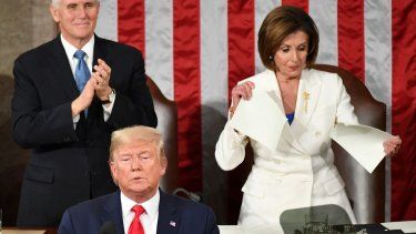 El vicepresidente de Estados Unidos, Mike Pence, aplaude mientras la presidenta de la Cámara de Representantes, Nancy Pelosi, rompe una copia del discurso del presidente Donald Trump, después de que él pronuncia el discurso sobre el Estado de la Unión en el Capitolio, en Washington, DC, el 4 de febrero de 2020.