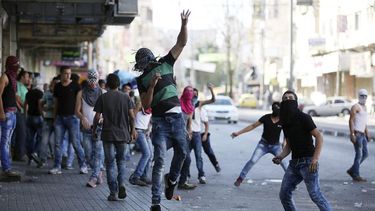 Manifestantes palestinos arrojan piedras contra soldados del ejército israelí durante un enfrentamiento en la ciudad cisjordana de Hebrón, Palestina. (EFE)
