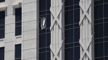Una cortina cuelga de una ventana rota en la torre de un hotel en el Caesars Palace Hotel & Casino, el martes 11 de julio de 2023 en Las Vegas.&nbsp;