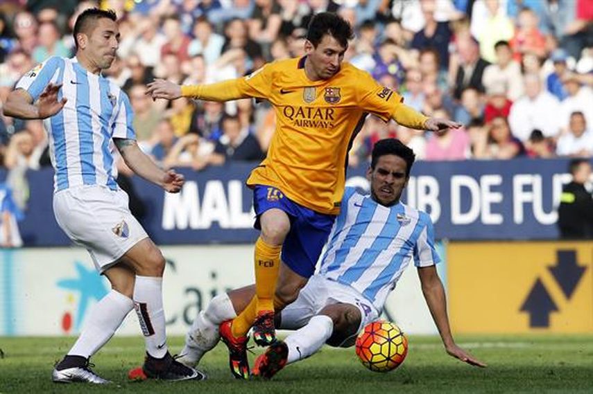 Messi lucha por el balón ante el delantero brasileño del Málaga Charles Dias (izquierda) y el centrocampista José Luis Garcia. (ARCHIVO)
