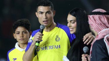 El portugués Cristiano Ronaldo (centro) saluda al público en compañía de su hijo Cristiano Jr. (izquierda) y su esposa Georgina Rodríguez.