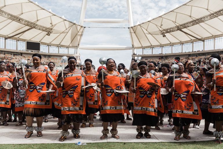 Mujeres vestidas con ropa tradicional de Swazilandia bailan en la coronación del rey Misuzulu Zulú en el Estadio Moses Mabhida en Durban el 29 de octubre de 2022.