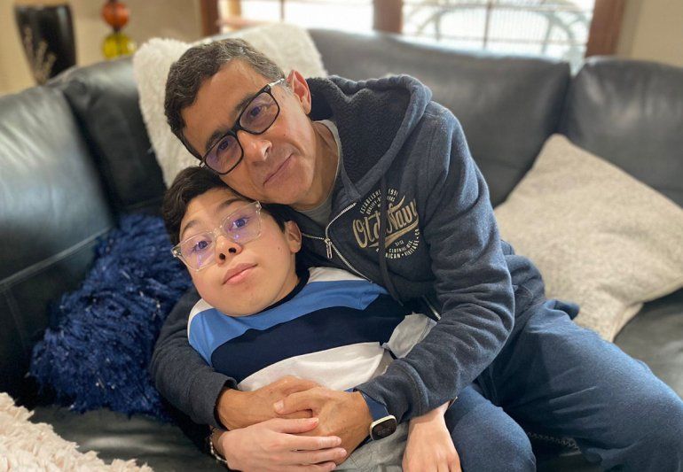 En esta imagen del miércoles 9 de marzo de 2022, cortesía de María Elena Cárdenas, se ve a Gustavo Cárdenas _uno de los seis ejecutivos petroleros encarcelados en Venezuela_ abrazando a su hijo Sergio, en su casa en Houston. 