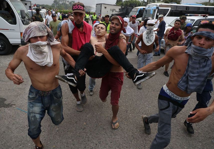 Manifestantes sacan a un joven herido durante las protestas en la frontera colombo venezolana.&nbsp;