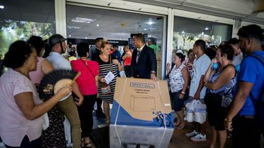 Un trabajador&nbsp;lleva un congelador recién comprado mientras otras personas hacen cola en una tienda en La Habana, Cuba, el lunes 28 de octubre de 2019.