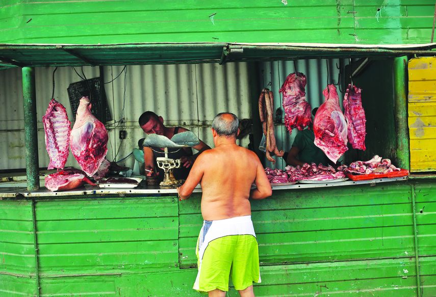 Un hombre compra carne de cerdo en un puesto callejero en La Habana, la única que se puede adquirir.