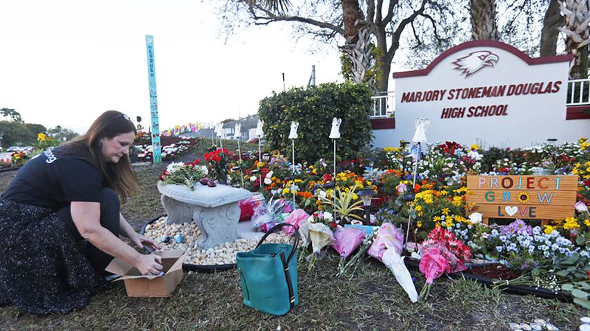 Una vecina de Parkland deposita flores frente al instituto Marjory Stoneman Douglas, en Broward, al norte de Miami.