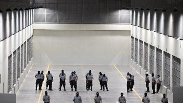 Oficiales de seguridad de la prisión del gobierno montan guardia dentro de la prisión recién inaugurada, en El Salvador.