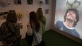 La gente recorre la exposición Diego Eterno, un viaje inmersivo a través de la vida del astro del fútbol argentino Diego Maradona, en La Rural de Buenos Aires el 2 de diciembre de 2024.