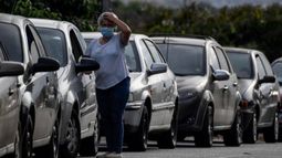 Un conductor reacciona mientras espera en una cola para repostar el tanque de gasolina de su automóvil cerca de una estación de servicio en Caracas el 7 de abril de 2020.
