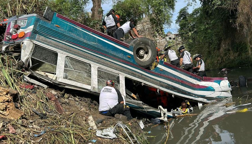 Bomberos voluntarios trabajan en el lugar de un accidente en el que un autobús cayó por un barranco en la Ciudad de Guatemala el 10 de febrero de 2025. Más de 50 personas murieron el lunes cuando un autobús chocó contra una barandilla y se hundió en un barranco, dijeron los rescatistas, uno de los peores accidentes de tráfico en América Latina en años.