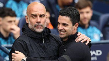 El técnico español del Manchester City, Pep Guardiola (izquierda), abraza al técnico español del Arsenal, Mikel Arteta, antes del inicio del partido de la Premier League inglesa entre el Manchester City y el Arsena