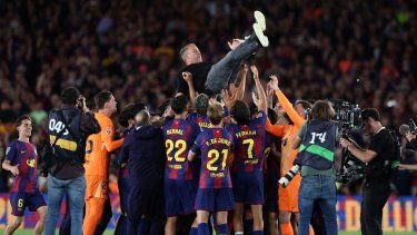 Los jugadores del Barcelona celebran con el entrenador alemán Hans-Dieter Flick la victoria en el partido de la liga española entre el FC Barcelona y el Real Madrid CF en el estadio Camp Nou de Barcelona el 10 de mayo de 2026.