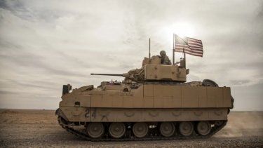 Soldado estadounidense conduce un vehículo de combate Bradley